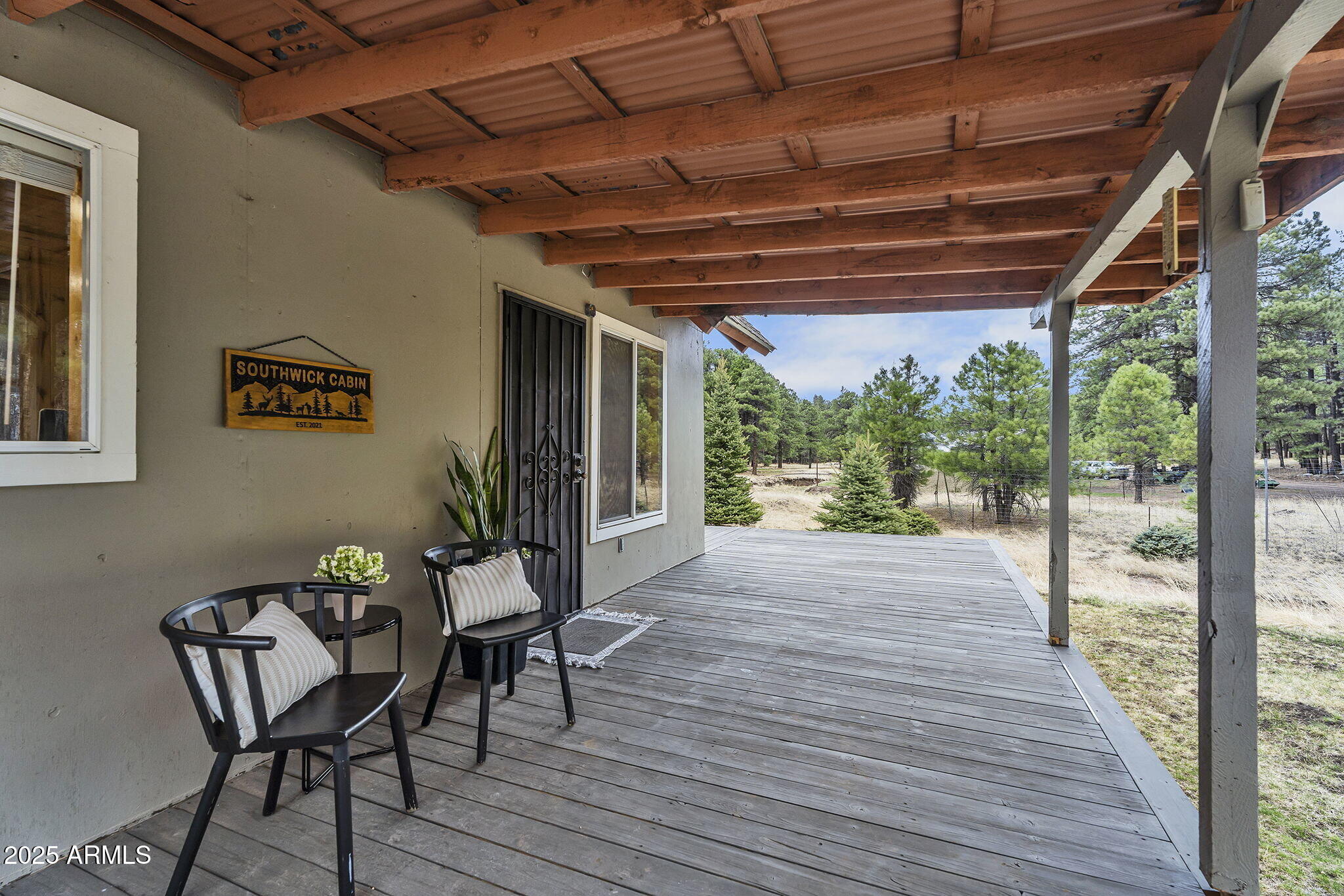 5348 Forest Service 701 Road Happy Jack, AZ 86024 - Photo 4 of 59 a patio with wooden floor a yard a table and chairs