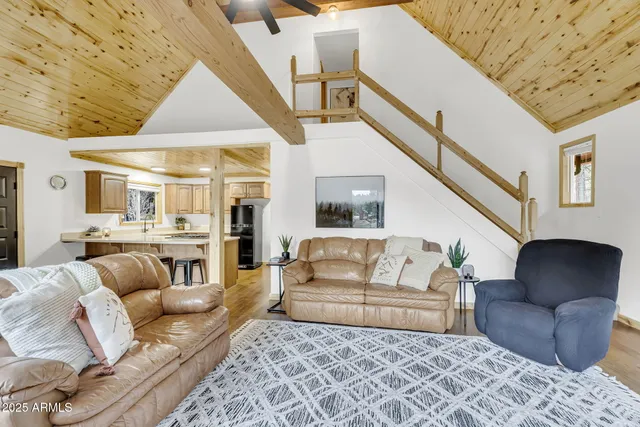 a patio with wooden floor a yard a table and chairs