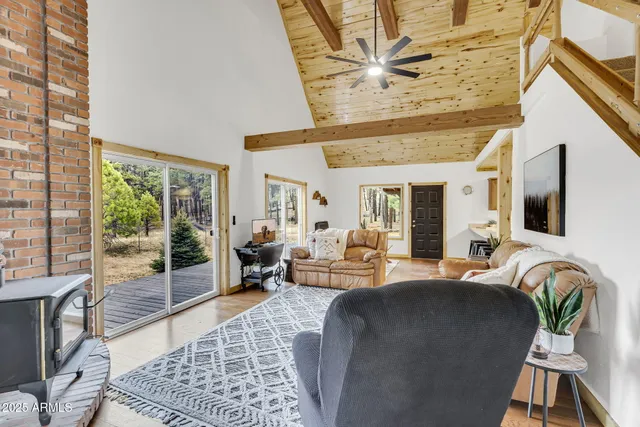 a living room with furniture and a floor to ceiling window