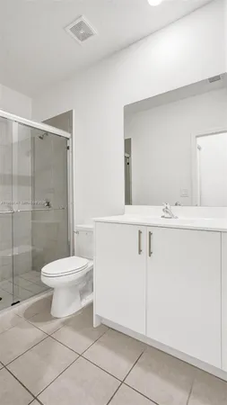 a bathroom with a toilet sink and shower