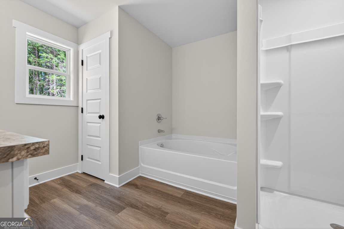 206 Airport Road, Unit 11 Canon, GA 30520 - Photo 25 of 34 a bathroom with a bathtub and a shower