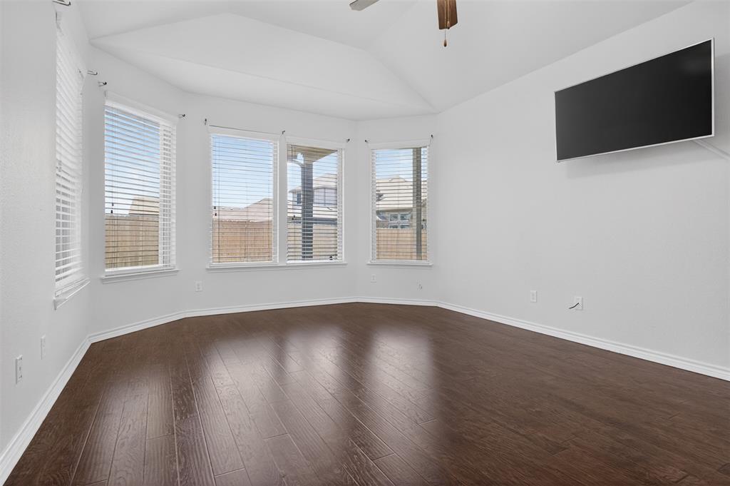 8728 Maple Ridge Trail Fort Worth, TX 76244 - Photo 20 of 40 Room featuring wood-finish flooring, a vaulted ceiling, and a ceiling fan