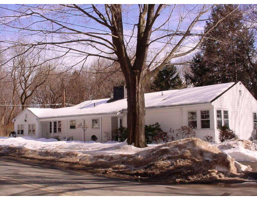 91 Grant Street Lexington, MA 02420 - Photo 1 of 8 a view of a white house with a large tree