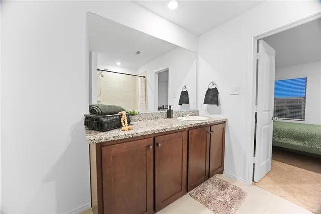 a en suite bathroom with a sink and a mirror