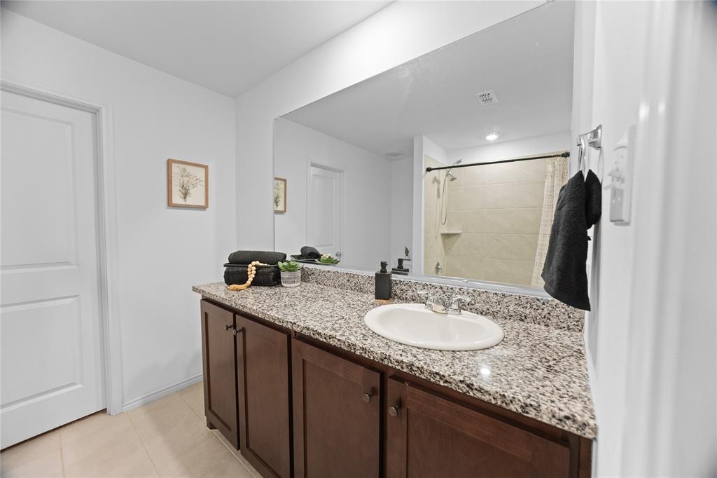 6436 Auburn Dl Road Pilot Point, TX 76258 - Photo 12 of 22 a bathroom with a granite countertop sink and a mirror