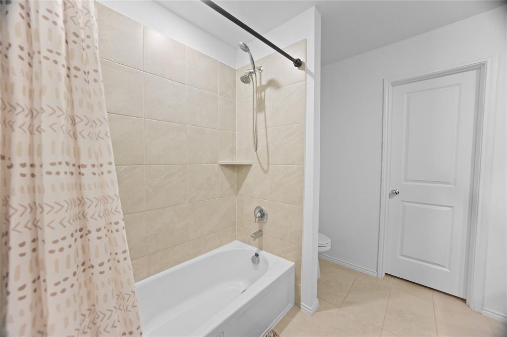 6436 Auburn Dl Road Pilot Point, TX 76258 - Photo 17 of 22 a bathroom with a bathtub and a shower