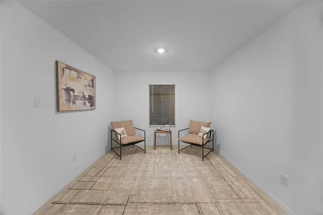 a living room with furniture and a chair