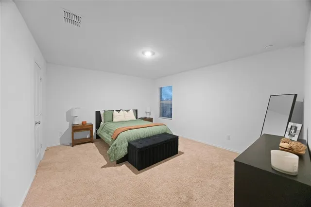 a bedroom with a bed and window