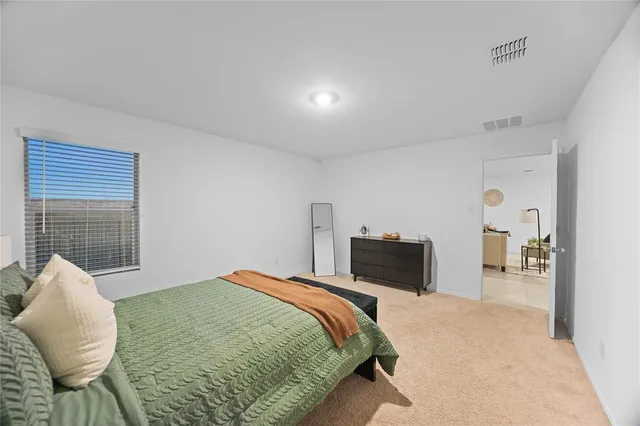 a bedroom with a bed and chair