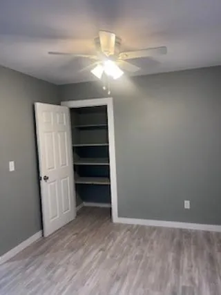 a view of a room with a closet and wooden floor