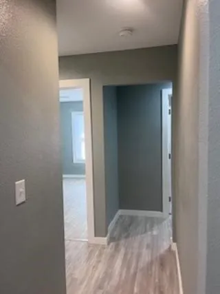 a view of a hallway with wooden floor