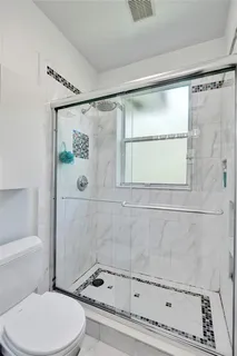 a bathroom with a toilet and shower