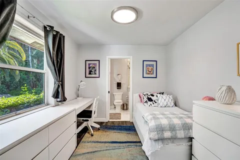 a bedroom with furniture and a wooden floor