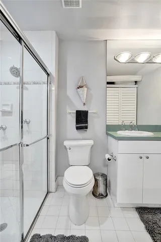 a bathroom with a toilet sink and shower