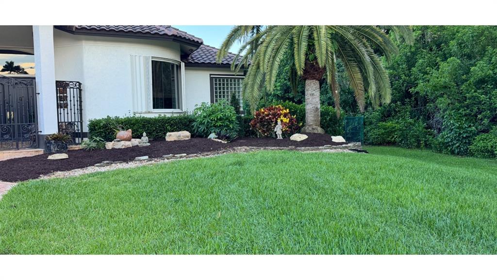 11720 Northwest 9th Street Plantation, FL 33325 - Photo 3 of 39 a backyard of a house with seating space