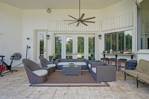 a living room with furniture windows and a chandelier