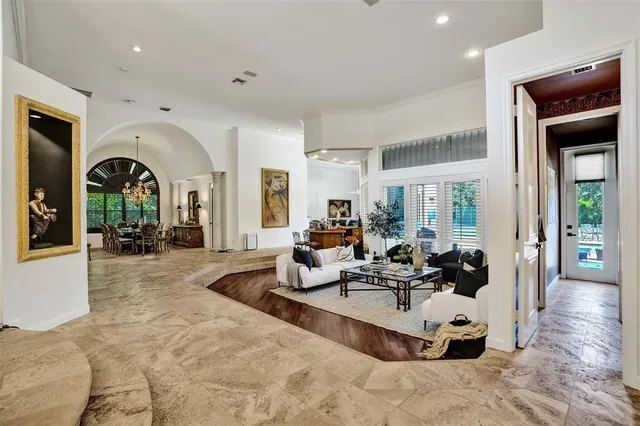 a living room with furniture large window and flat screen tv