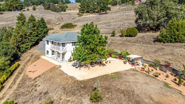 an aerial view of a house with a yard