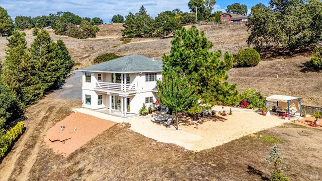 an aerial view of a house with a yard