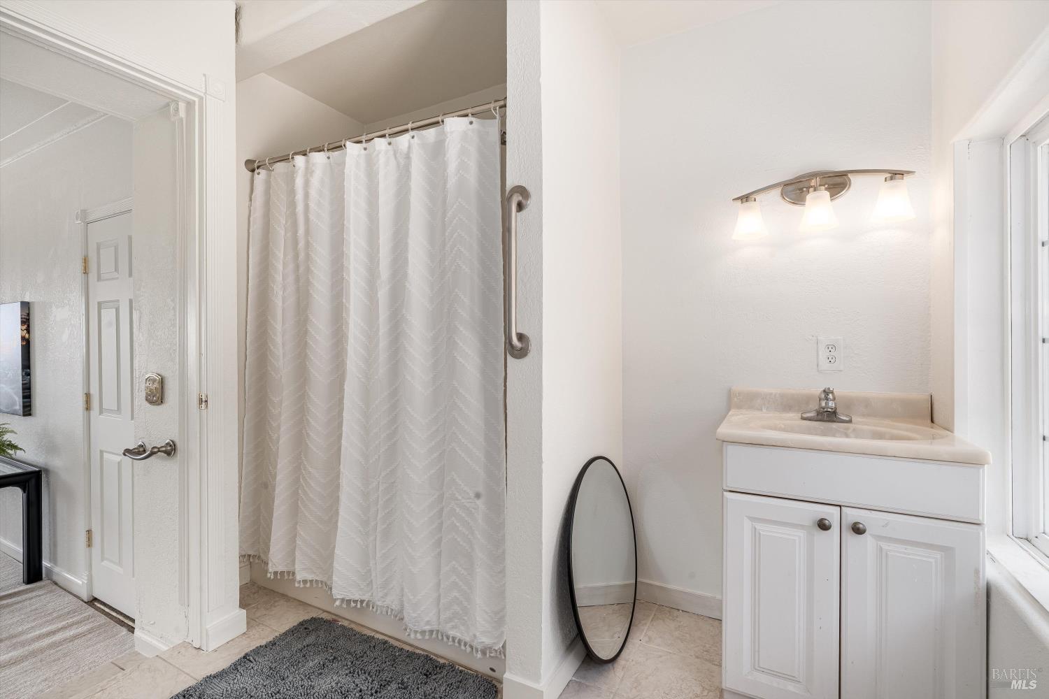 6001 Lichau Road Penngrove, CA 94951 - Photo 37 of 86 a bathroom with a sink a mirror and a shower