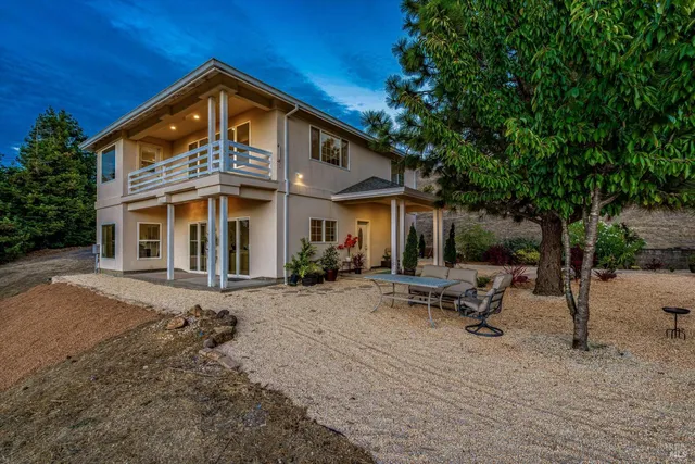 an aerial view of a house with a yard