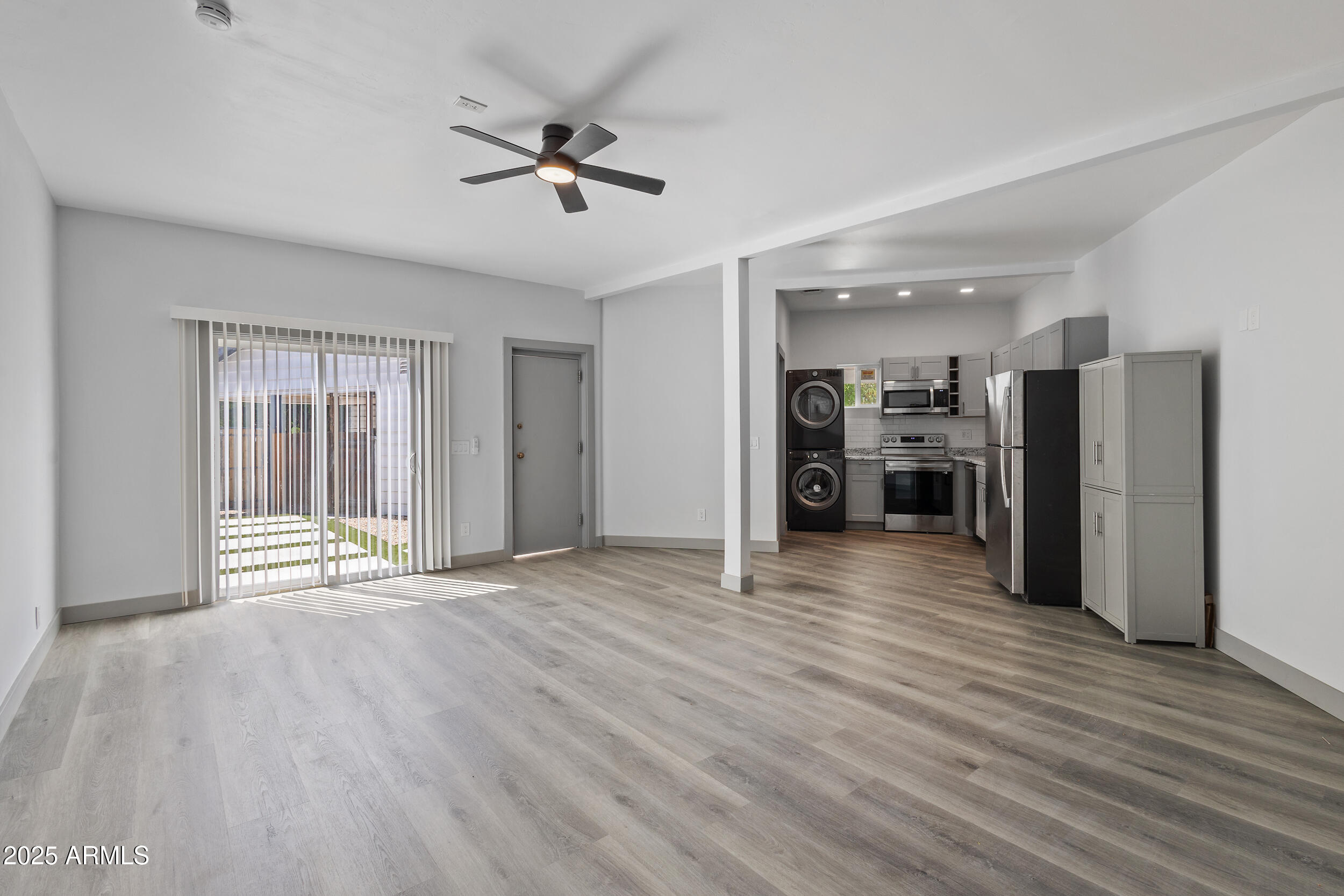 4536 North 18th Drive Phoenix, AZ 85015 - Photo 26 of 29 a view of a livingroom with a hardwood floor and a ceiling fan