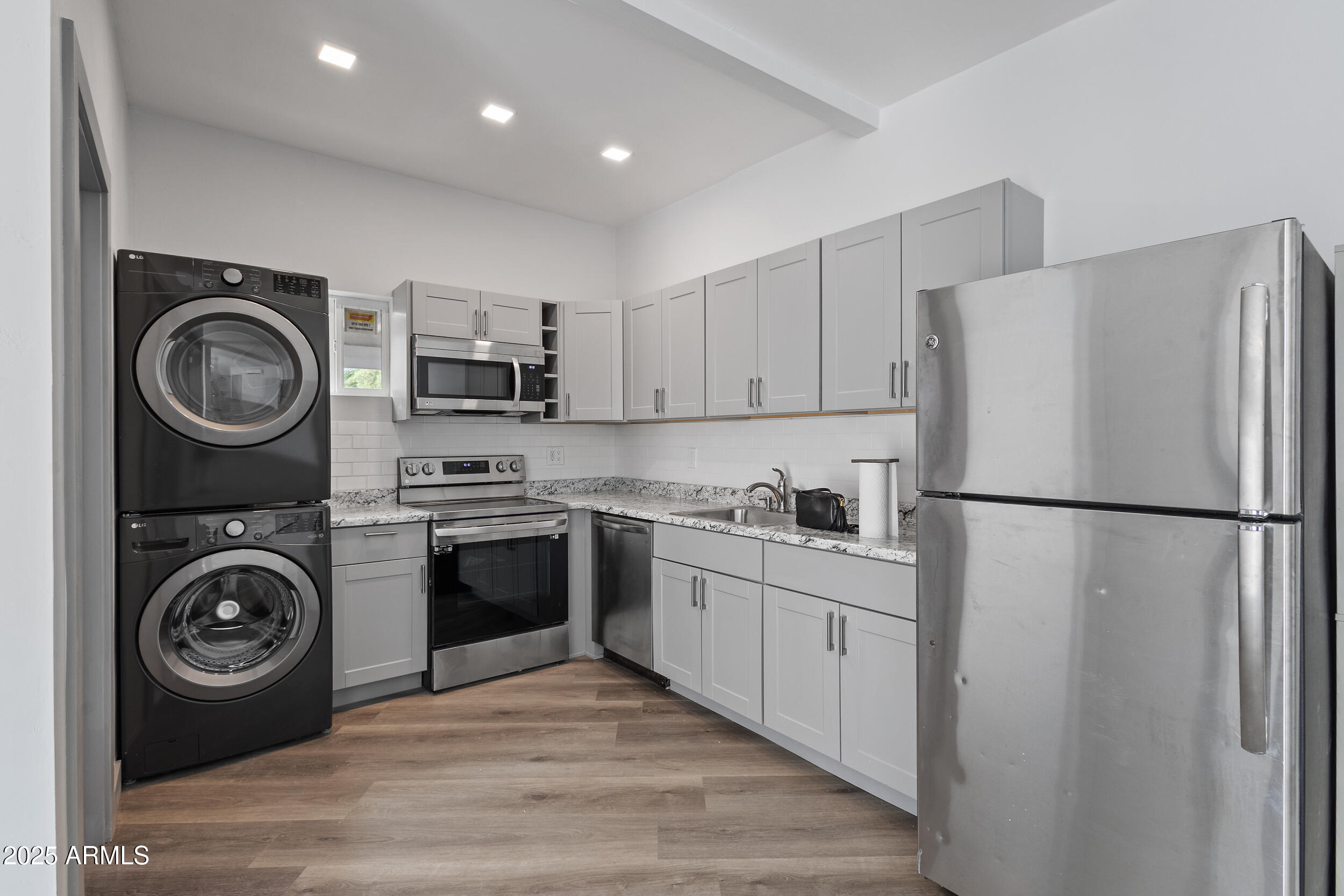 4536 North 18th Drive Phoenix, AZ 85015 - Photo 28 of 29 a kitchen with a refrigerator sink and stove top oven
