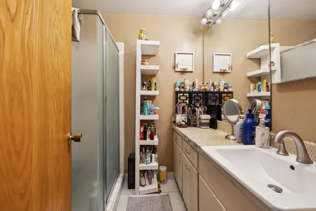 a bathroom with a sink double vanity and shower
