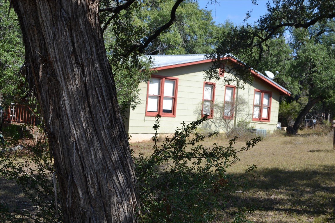 8409 Appaloosa Run Austin, TX 78737 - Photo 11 of 40 a view of a house with a small yard and a large tree