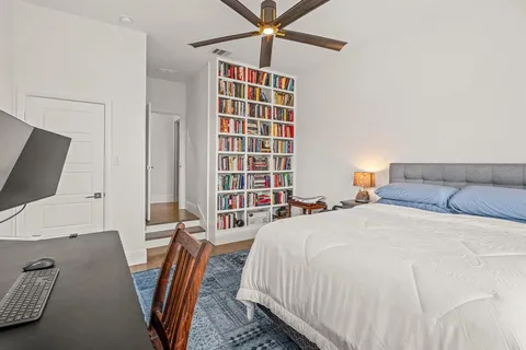 a bedroom with a bed and flat screen tv