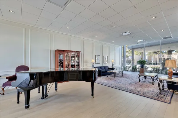 a living room with furniture a large window and a table