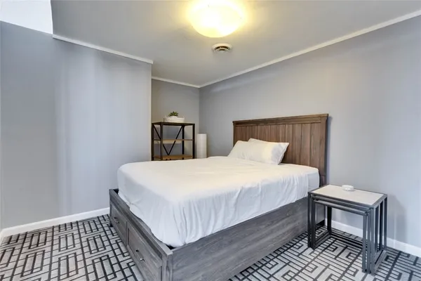a bedroom with a bed and a table