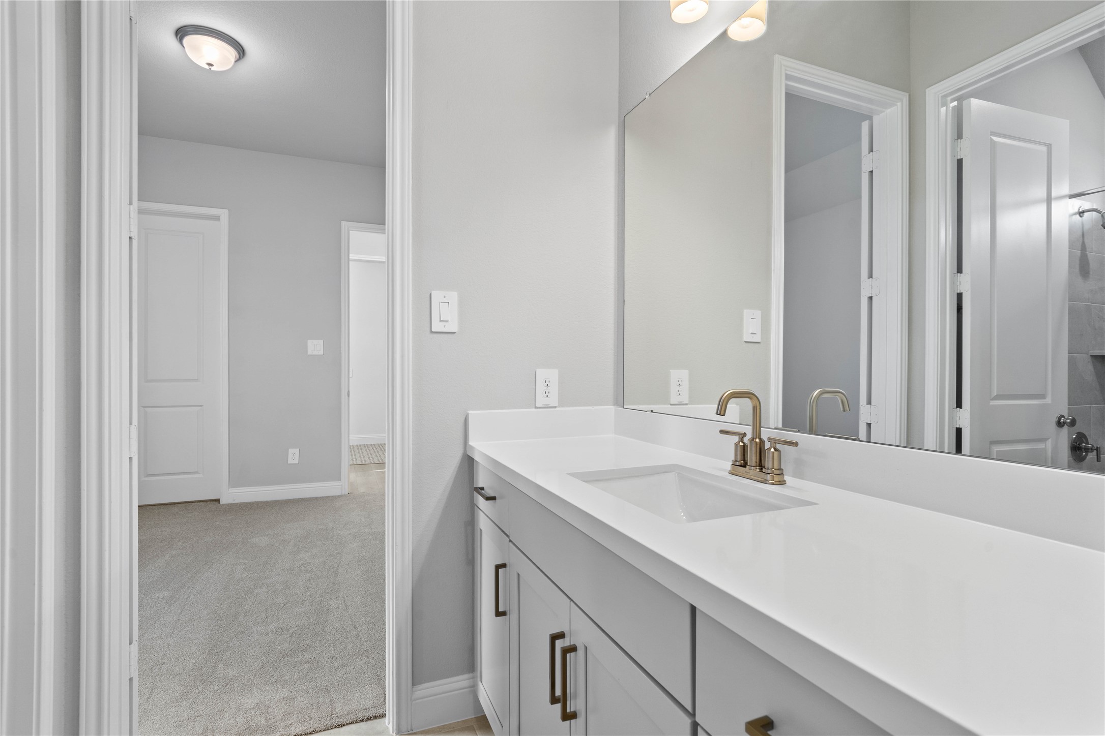 17020 Sweet Iris Court Conroe, TX 77302 - Photo 12 of 50 This well-appointed full bath serves two secondary bedrooms and features a convenient private entrance from one. Highlights include a versatile tub/shower combination and an expansive vanity topped with a sleek undermount sink.
