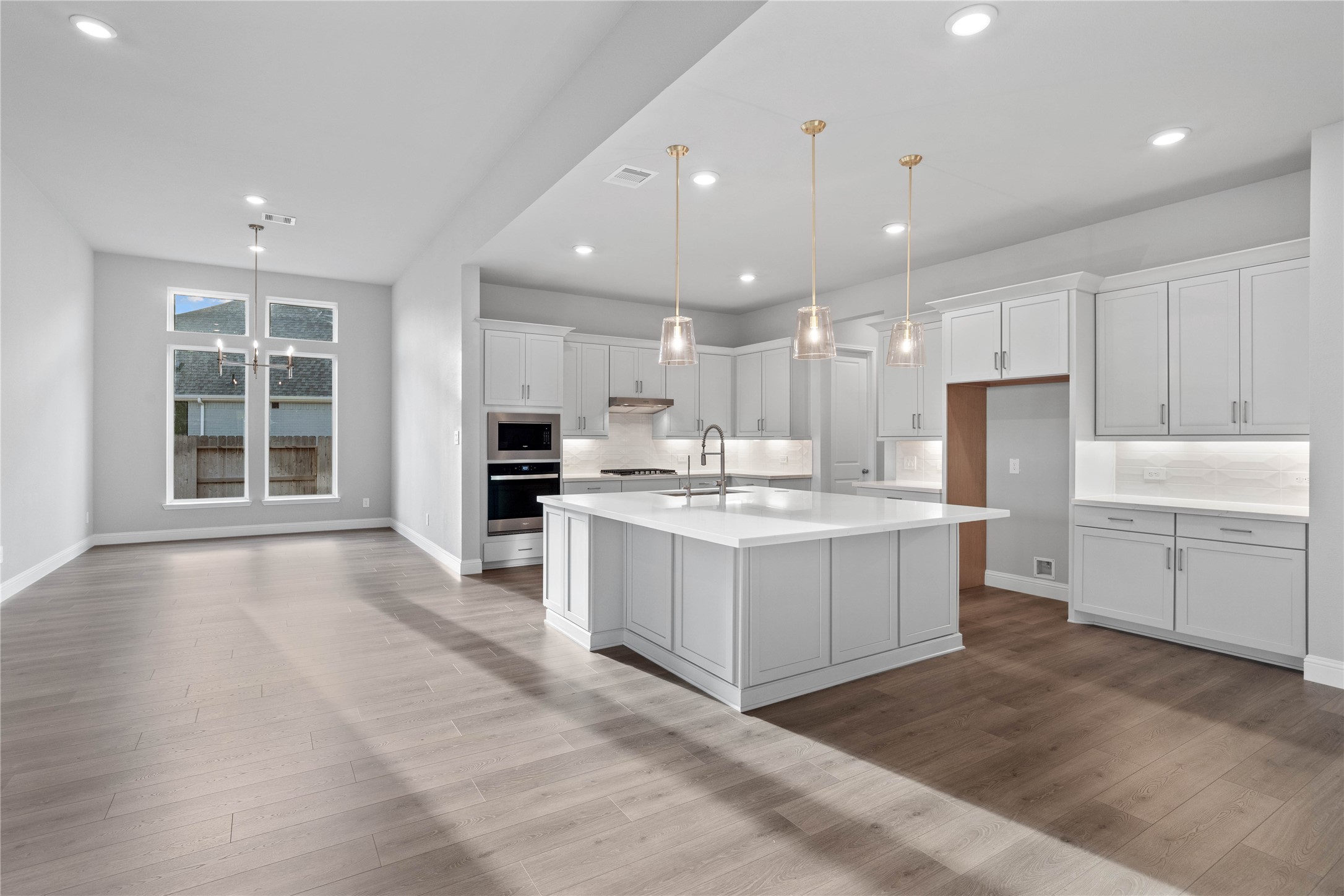 17020 Sweet Iris Court Conroe, TX 77302 - Photo 24 of 50 The intentional open design fosters a deep sense of connection between all three primary living zones. Sightlines remain clear from the sink to the breakfast table, promoting inclusive living and effortless entertaining.