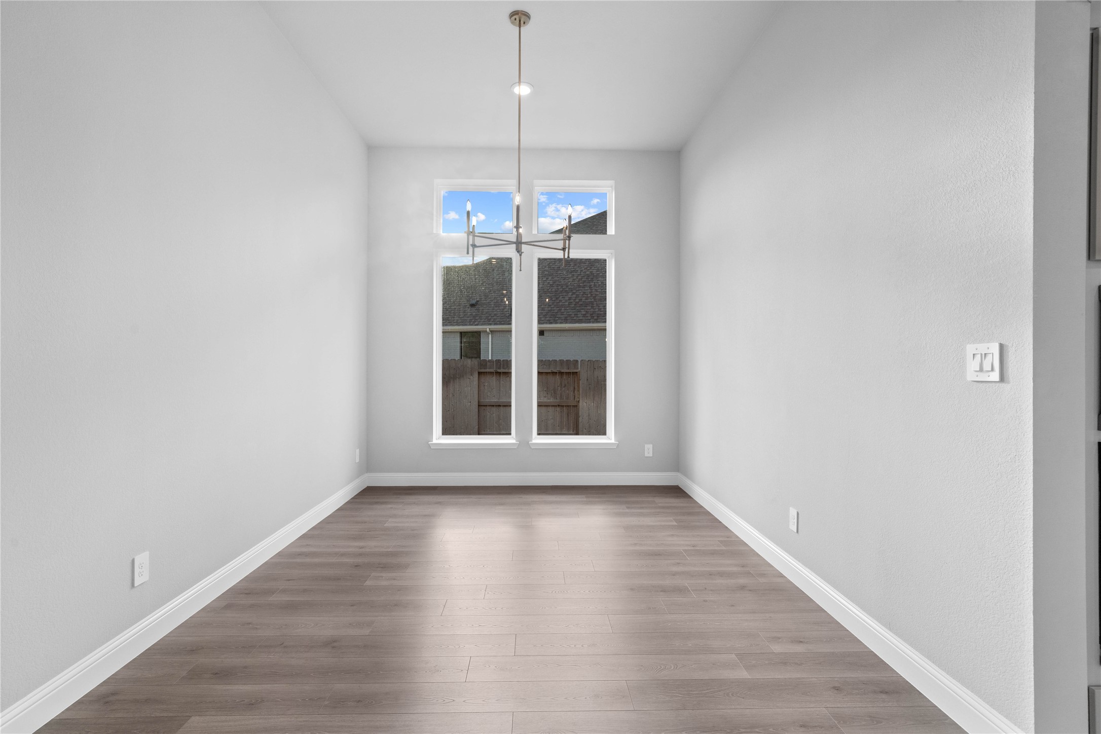 17020 Sweet Iris Court Conroe, TX 77302 - Photo 25 of 50 This breakfast/dining room is defined by its soaring ceilings and a modern chandelier, with large windows that bathe the neutral-toned space in natural light.