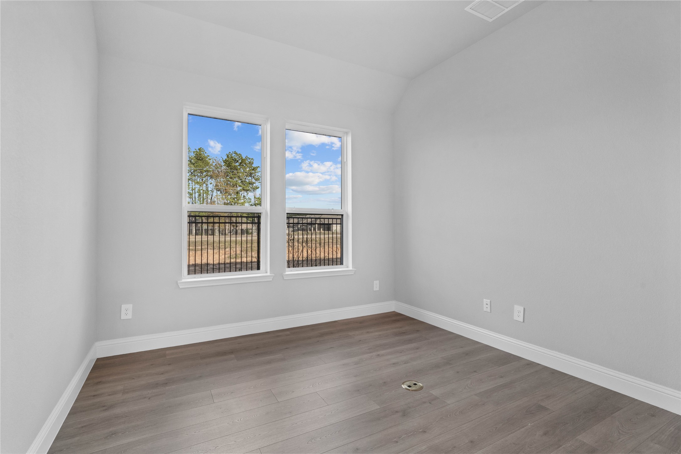 17020 Sweet Iris Court Conroe, TX 77302 - Photo 30 of 50 This handsome home office features laminate flooring, large windows, high sloped ceilings, and custom paint!