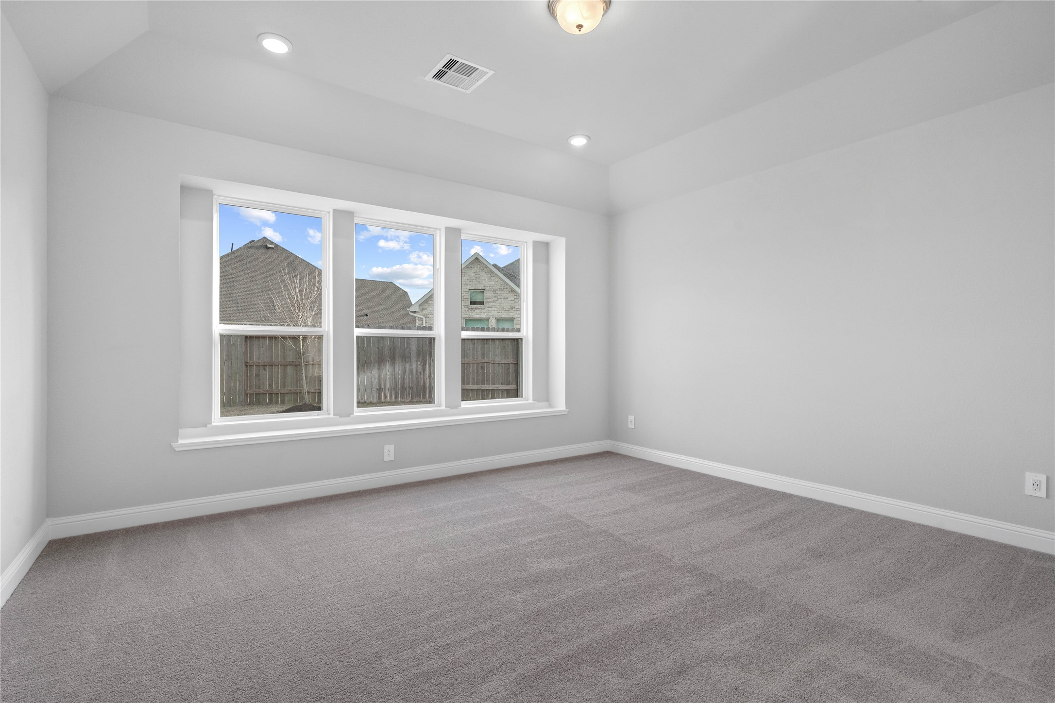 17020 Sweet Iris Court Conroe, TX 77302 - Photo 36 of 50 Relax and unwind after a long day in this impressive primary suite! This generously sized room offers plush carpet flooring, neutral-toned paint, high sloped ceilings, and large windows with seating sill!