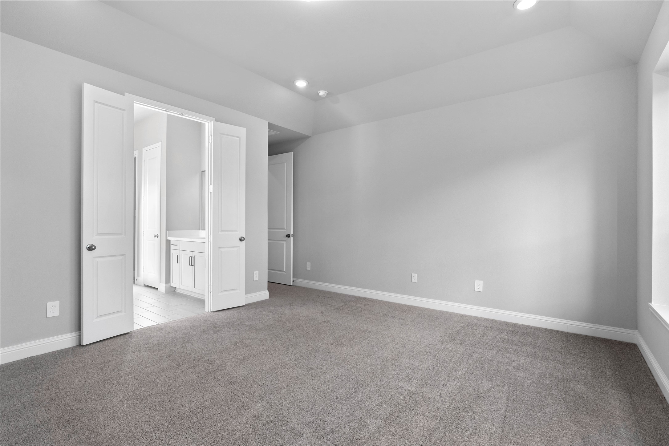 17020 Sweet Iris Court Conroe, TX 77302 - Photo 37 of 50 Additional view from primary bedroom looking towards the double door entrance to primary bathroom.