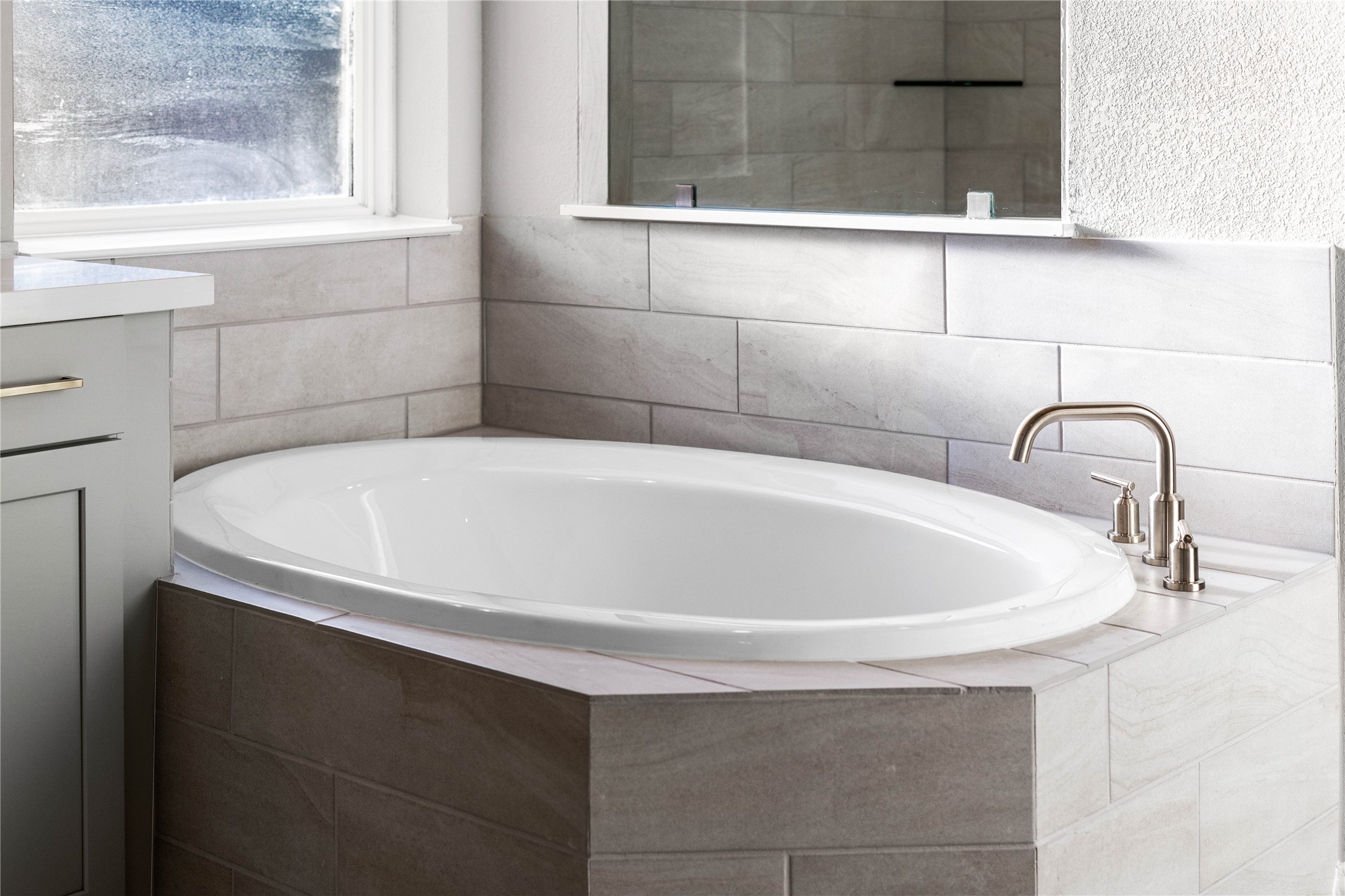 17020 Sweet Iris Court Conroe, TX 77302 - Photo 39 of 50 Unwind after a long day in the deep, corner soaking tub, a perfect sanctuary for relaxation. The tub is accented by stylish fixtures.