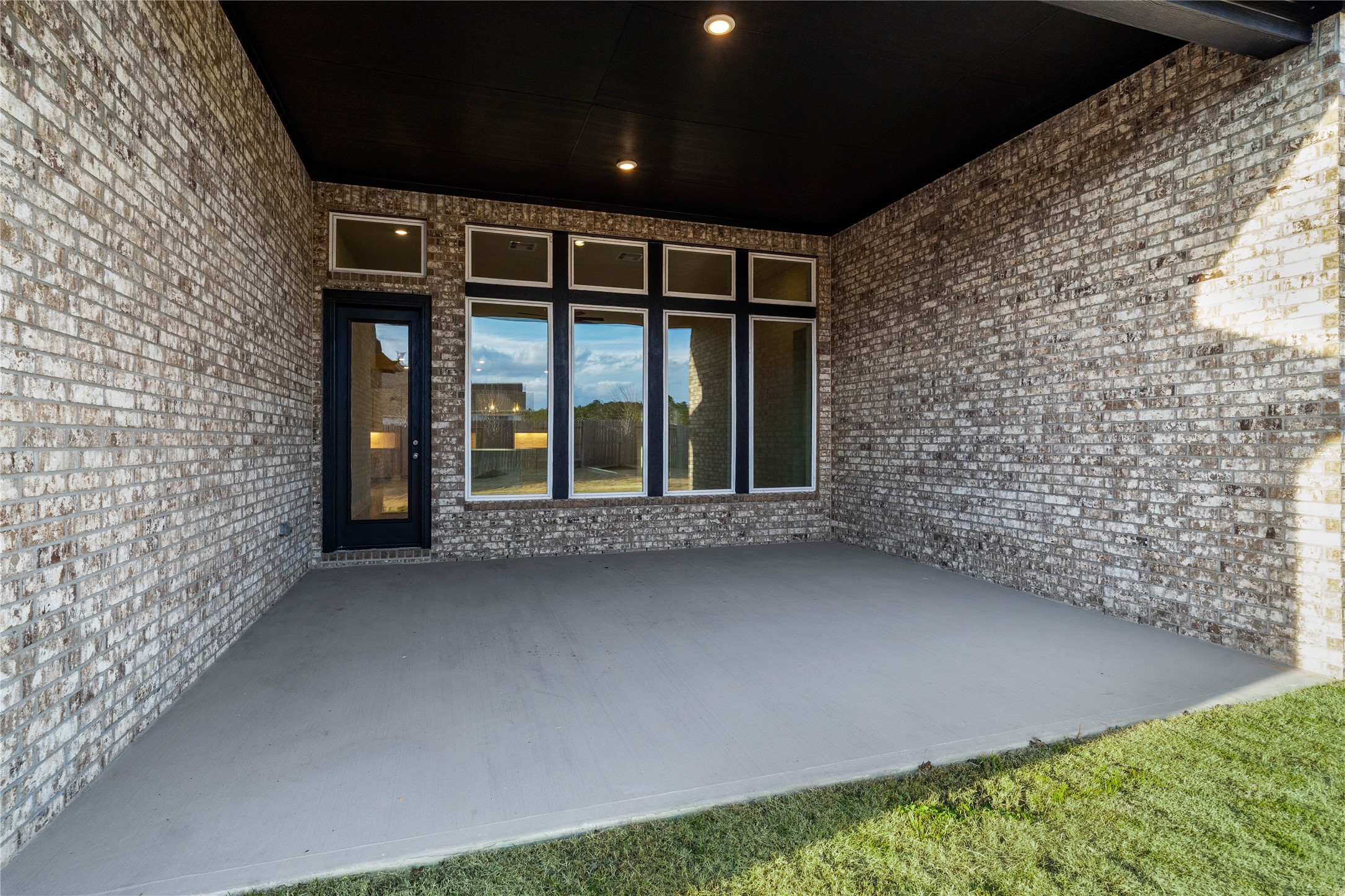 17020 Sweet Iris Court Conroe, TX 77302 - Photo 42 of 50 Step outside to the covered rear patio, the perfect extension of your indoor living space for year-round enjoyment.