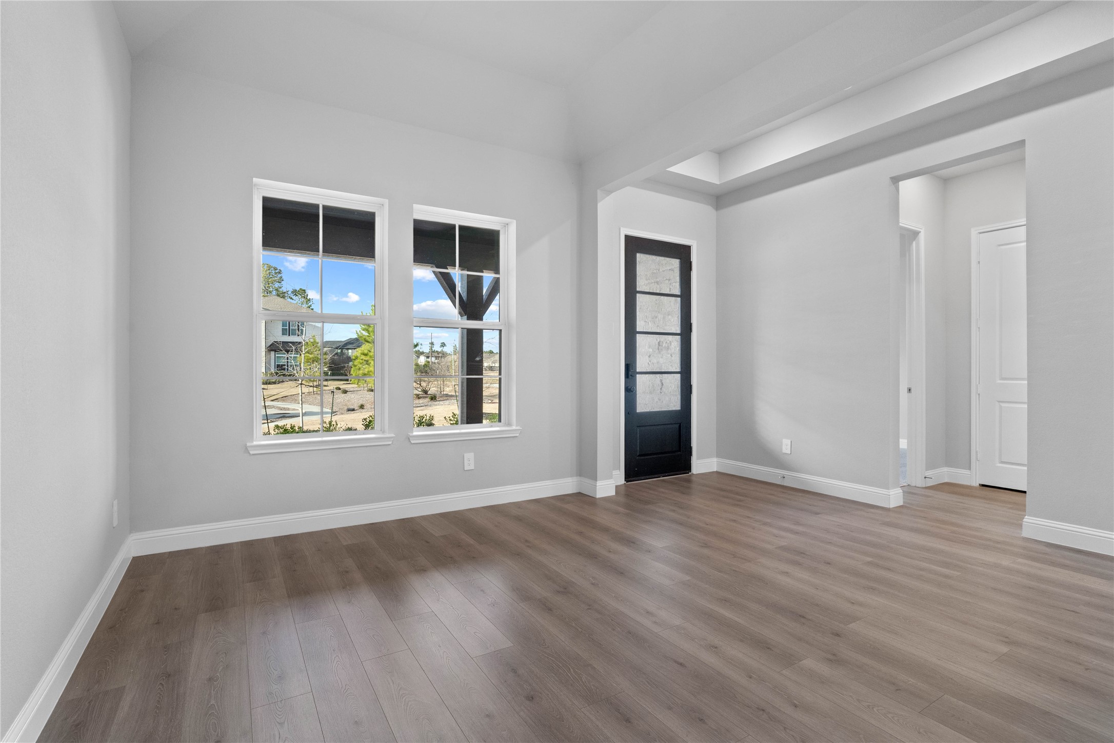 17020 Sweet Iris Court Conroe, TX 77302 - Photo 9 of 50 Located at the front of the home, the formal dining room creates an immediate sense of grandeur with its soaring sloped ceilings and an abundance of natural light streaming through large, energy-efficient windows.