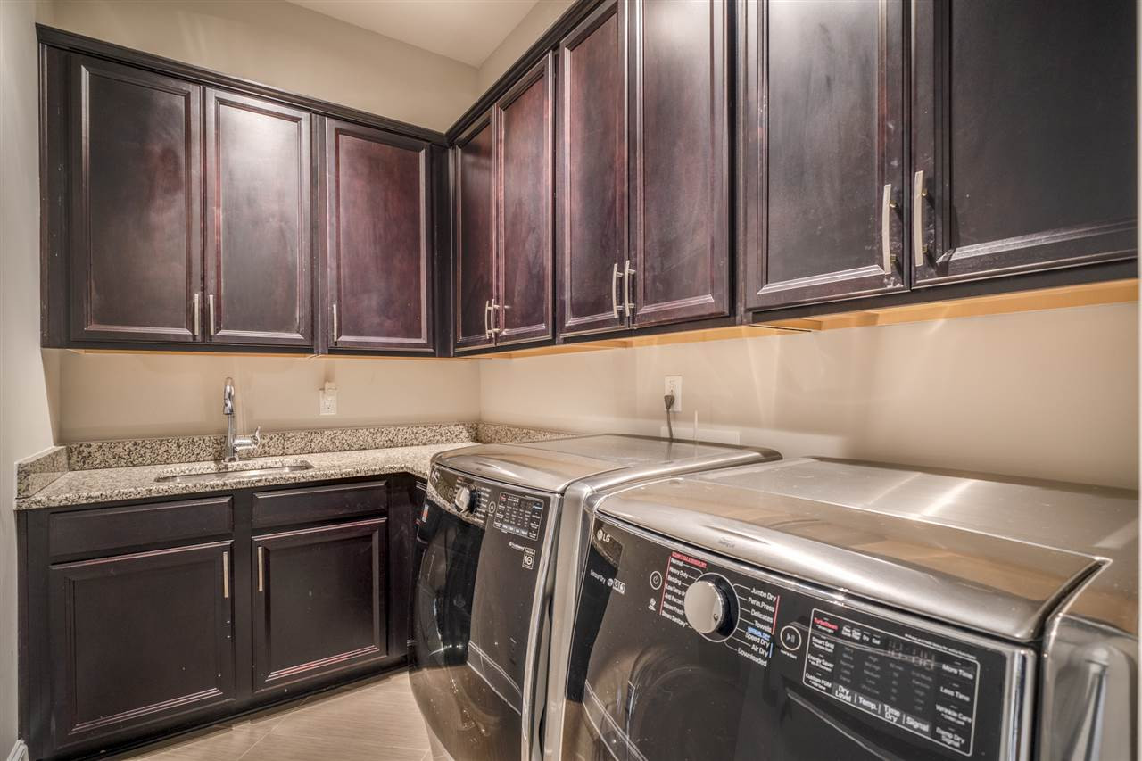7504 Pinaster Place Raleigh, NC 27613 - Photo 12 of 30 On main floor w/ cabinets & granite countertops overlooking mud room! Laundry