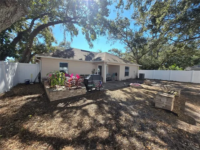 a view of a house with yard and sitting area