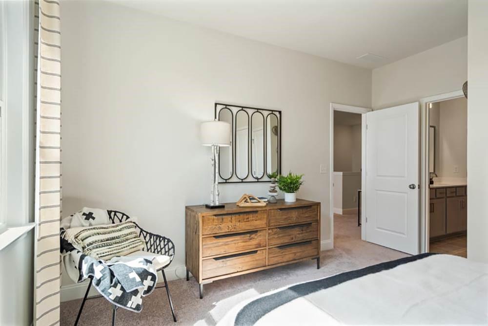 300 Meacham Court Dacula, GA 30019 - Photo 44 of 61 a bedroom with a bed and a dresser in it