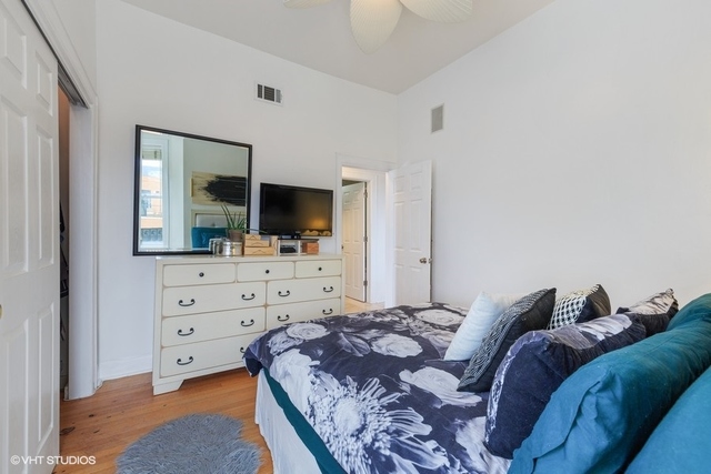 1049 West Altgeld Street, Unit 3A Chicago, IL 60614 - Photo 12 of 18 a living room with a bed and flat screen tv