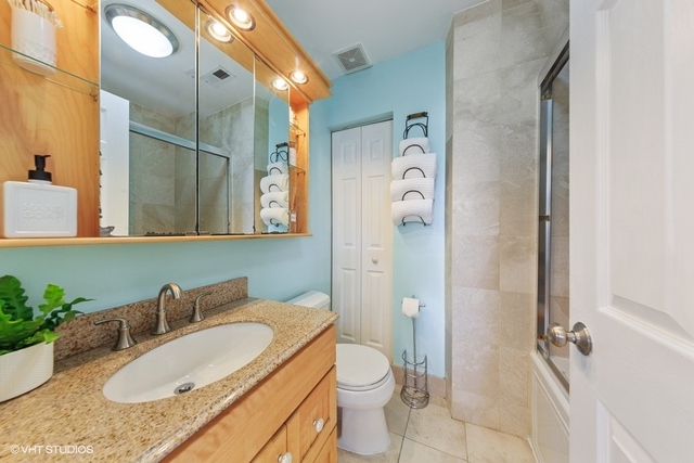 1049 West Altgeld Street, Unit 3A Chicago, IL 60614 - Photo 16 of 18 a bathroom with a granite countertop sink and a mirror