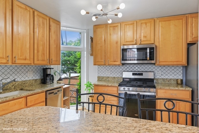 1049 West Altgeld Street, Unit 3A Chicago, IL 60614 - Photo 5 of 18 a kitchen with stainless steel appliances granite countertop a stove top oven a sink dishwasher and microwave oven
