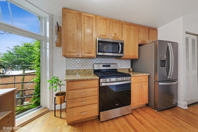 1049 West Altgeld Street, Unit 3A Chicago, IL 60614 - Photo 8 of 18 a kitchen with appliances a microwave and cabinets