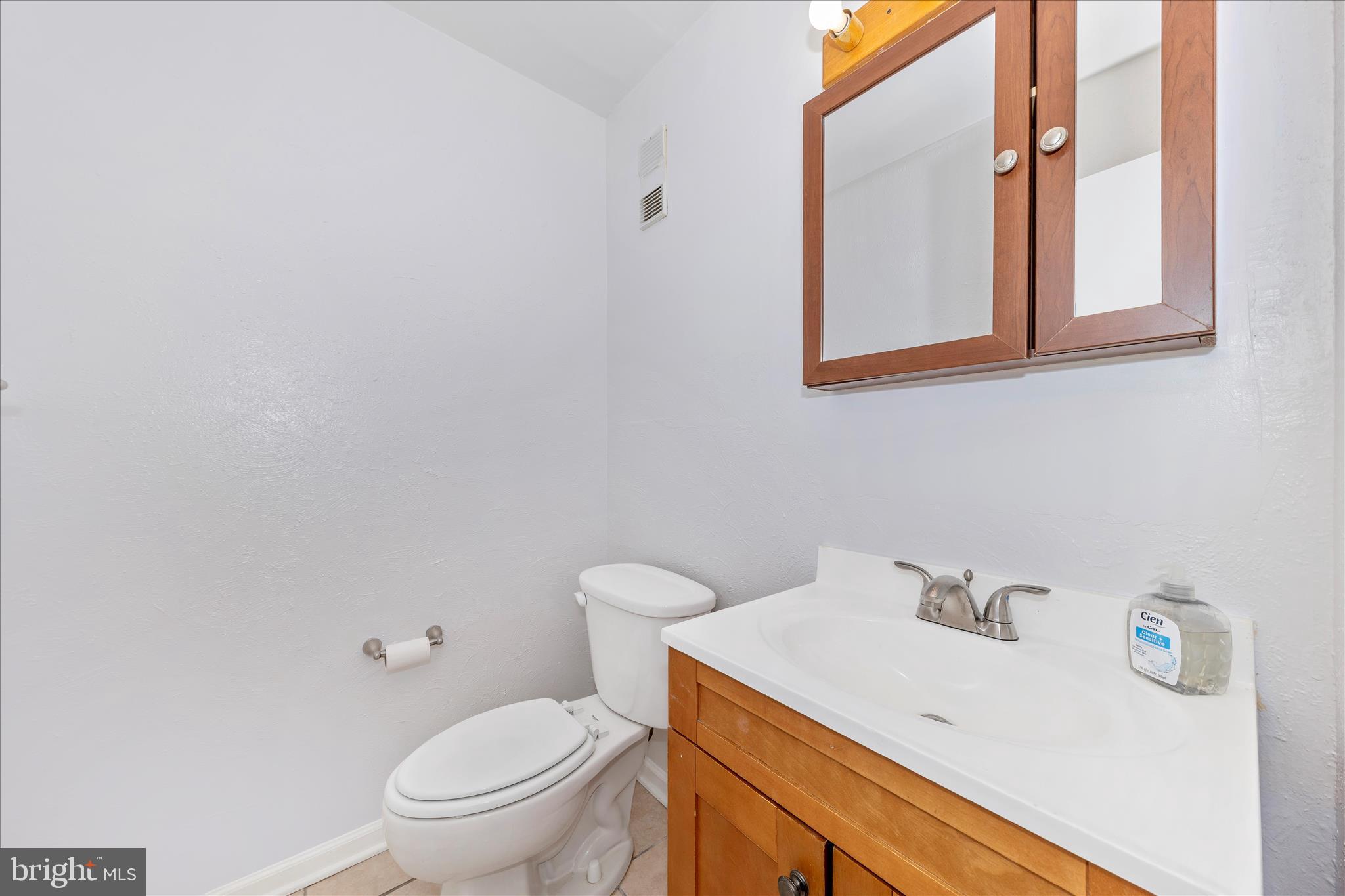 9989 Ridgeline Drive Montgomery Village, MD 20886 - Photo 11 of 26 a bathroom with a sink a toilet and a mirror