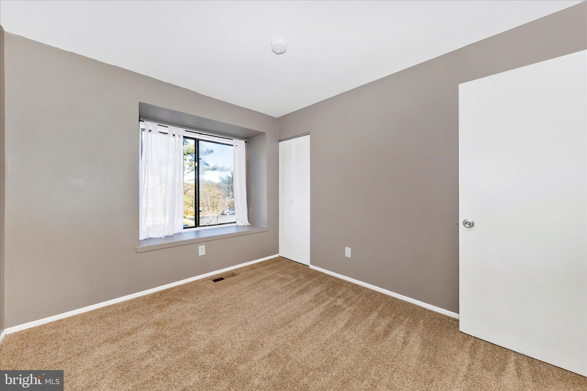 9989 Ridgeline Drive Montgomery Village, MD 20886 - Photo 18 of 26 a view of an empty room with a window